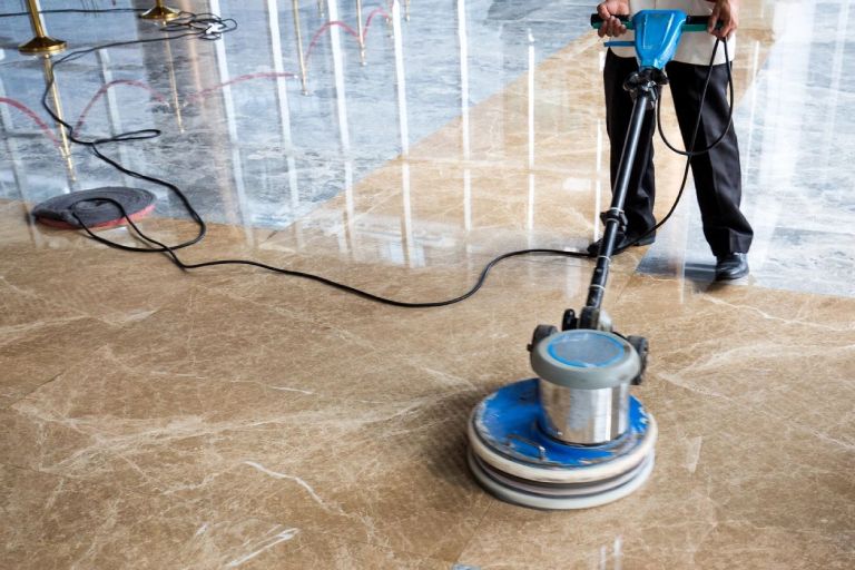 People polishes floor indoors