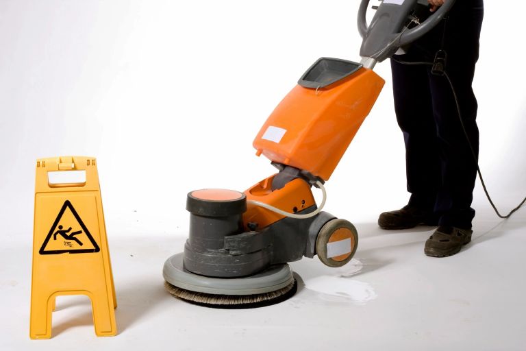 Cleaning the floor with machine